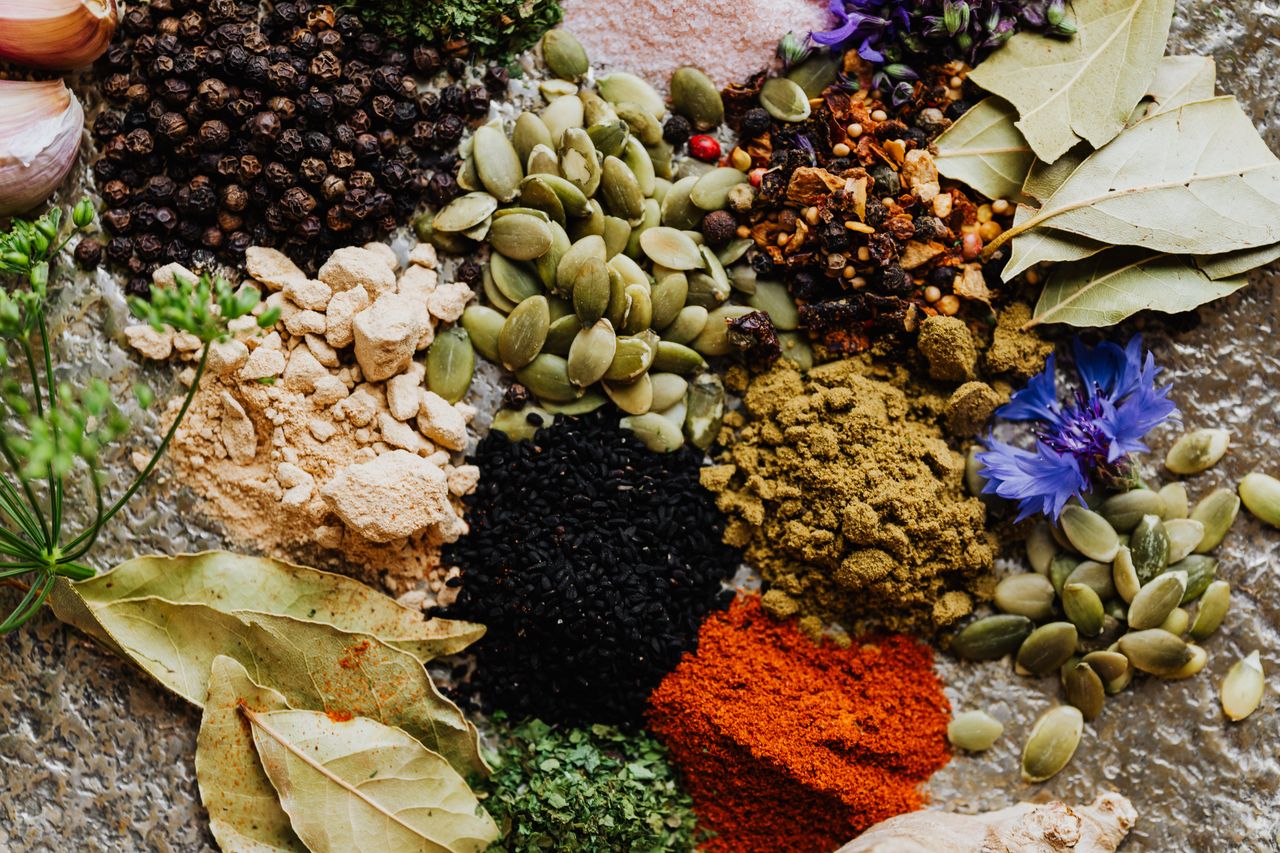Home High-quality flat lay of various spices and herbs, perfect for culinary arts or food blogging.